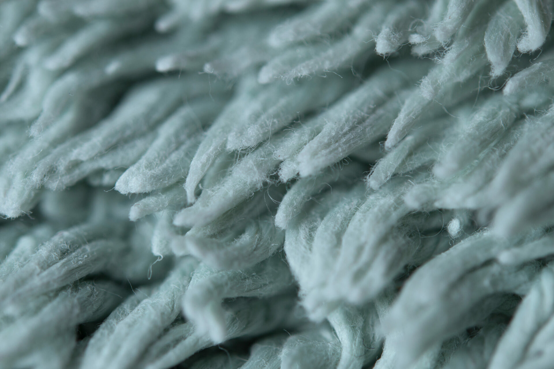 Blue carpet fibers close up.