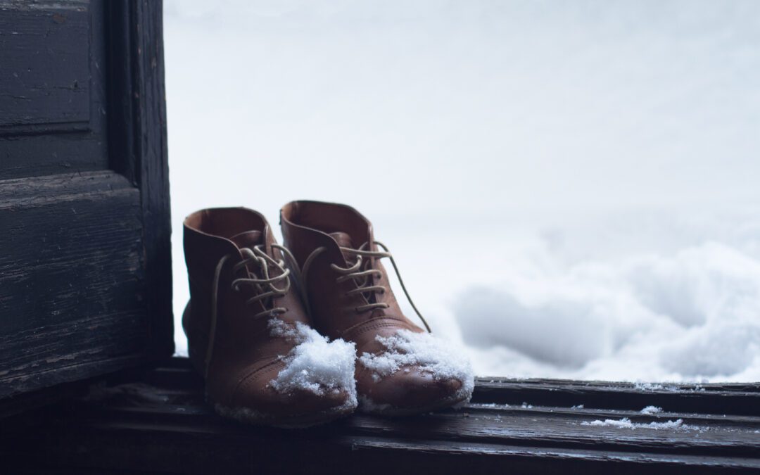 Snowy boots in an open doorway.