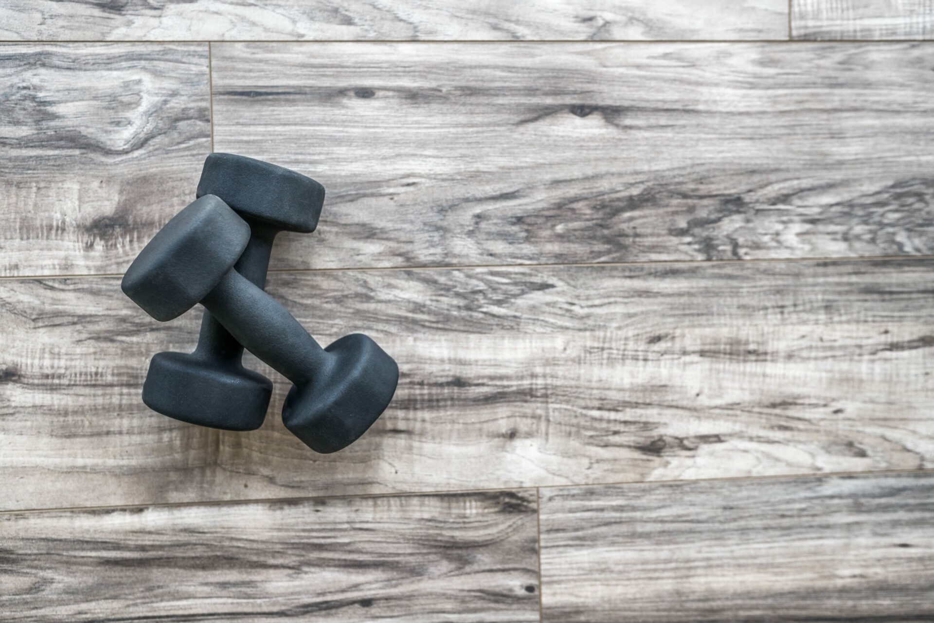 Luxury vinyl plank from Graham's Fort Collins flooring and dumbbells.